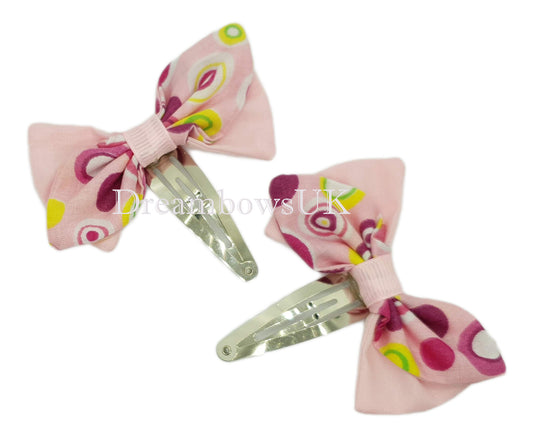 Pink spotty hair bows on snap clips