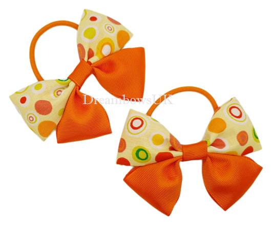 Orange polka dot hair bows on thick bobbles