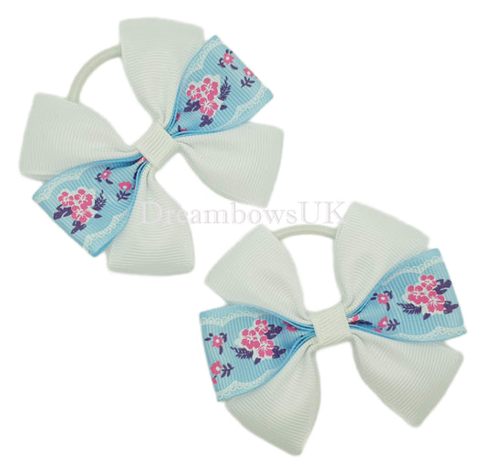 Baby blue and white floral hair bows on thin bobbles