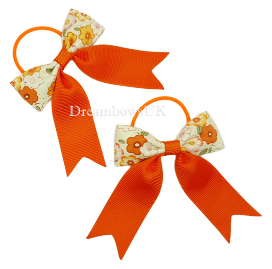 Orange floral hair bows on thin bobbles