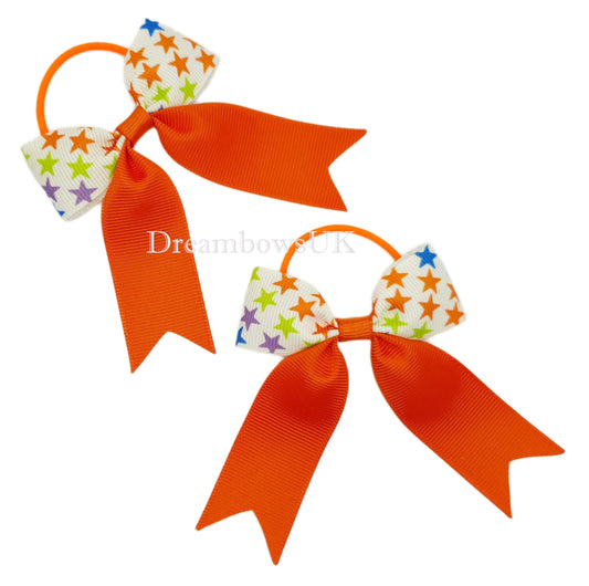 Orange star design hair bows on thin bobbles