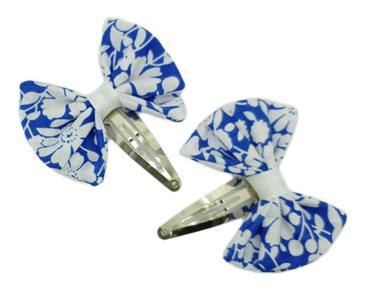 Royal blue and white floral bows on snap clips