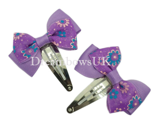 Purple floral hair bows on snap clips