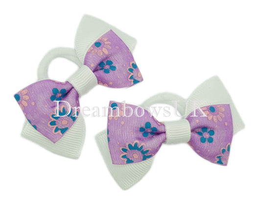 Purple and white floral hair bows on polyester bobbles