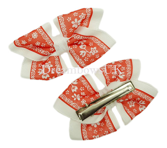 Red and white floral hair bows on alligator clips
