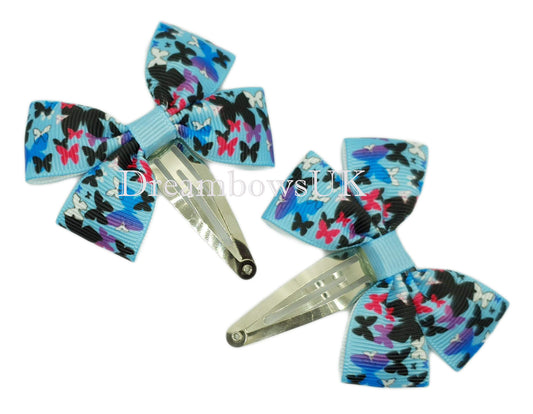 Blue butterfly design hair bows on snap clips