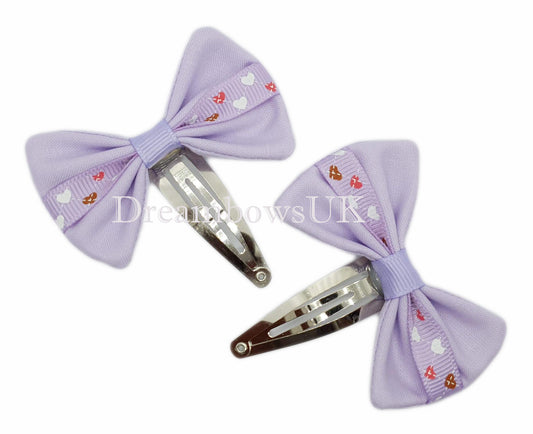 Lilac hearts design hair bows on snap clips