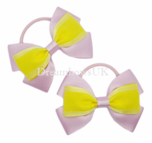 Baby pink and yellow organza hair bows on thin bobbles