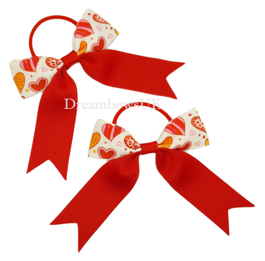 Red and white hearts design hair bows on thin bobbles