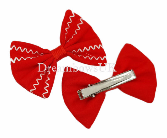 Red embroidered hair bows on alligator clips