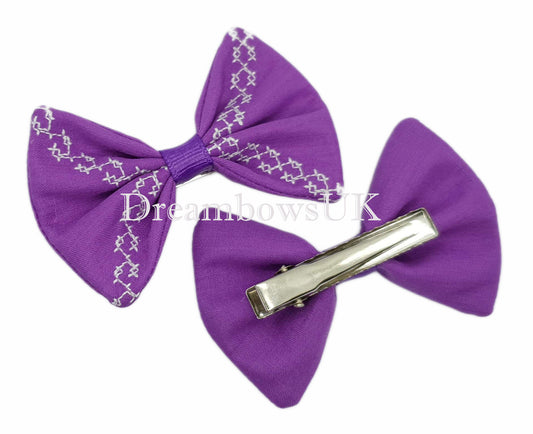 Purple embroidered hair bows on alligator clips
