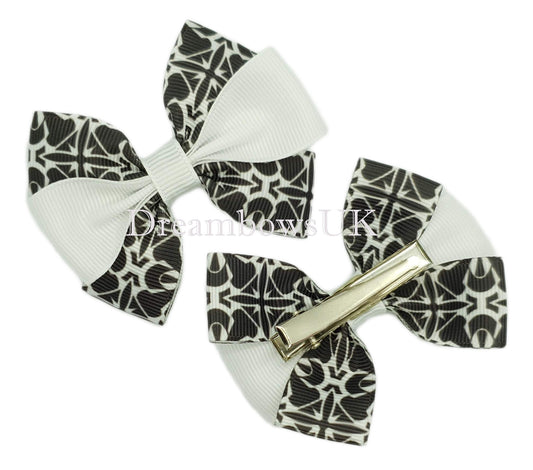 Black and white novelty hair bows on alligator clips.