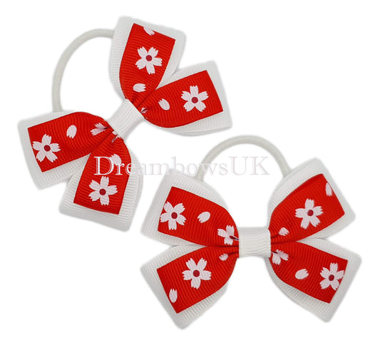 Red and white floral hair bows on thin bobbles