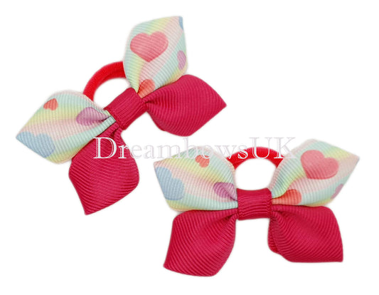 Cerise pink hearts design hair bows on polyester bobbles