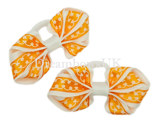 2x Orange and white novelty hair bows on polyester bobbles - DreambowsUK