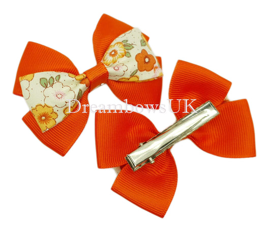Orange floral hair bows on alligator clips