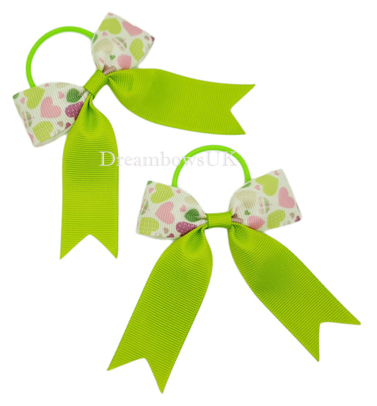 Lime green hearts design hair bows on thin bobbles 
