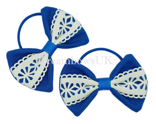 Royal blue and white floral bows on thin bobbles 