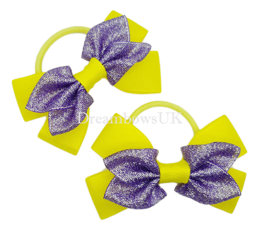 Purple and yellow glitter hair bows on thick bobbles