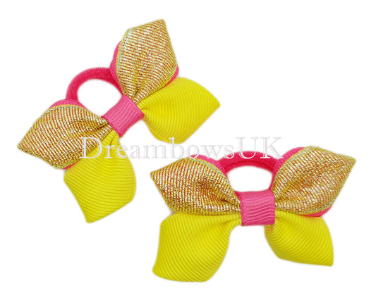 Pink and yellow glitter hair bows on polyester bobbles