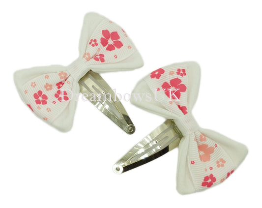 Pink and white floral hair bows on snap clips