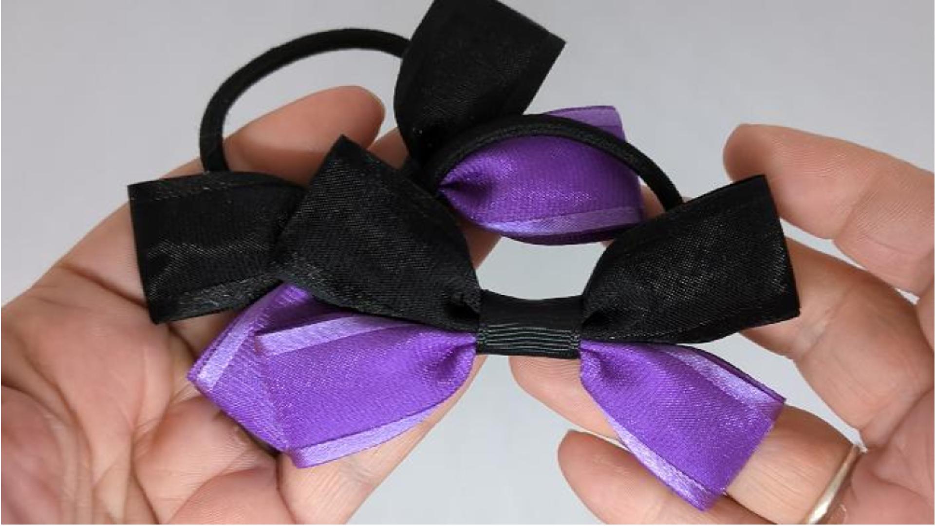 Close-up of black and purple hair bows on thick bobbles, measuring 9cm x 6cm, showcasing the contrast between the soft organza and grosgrain ribbon.