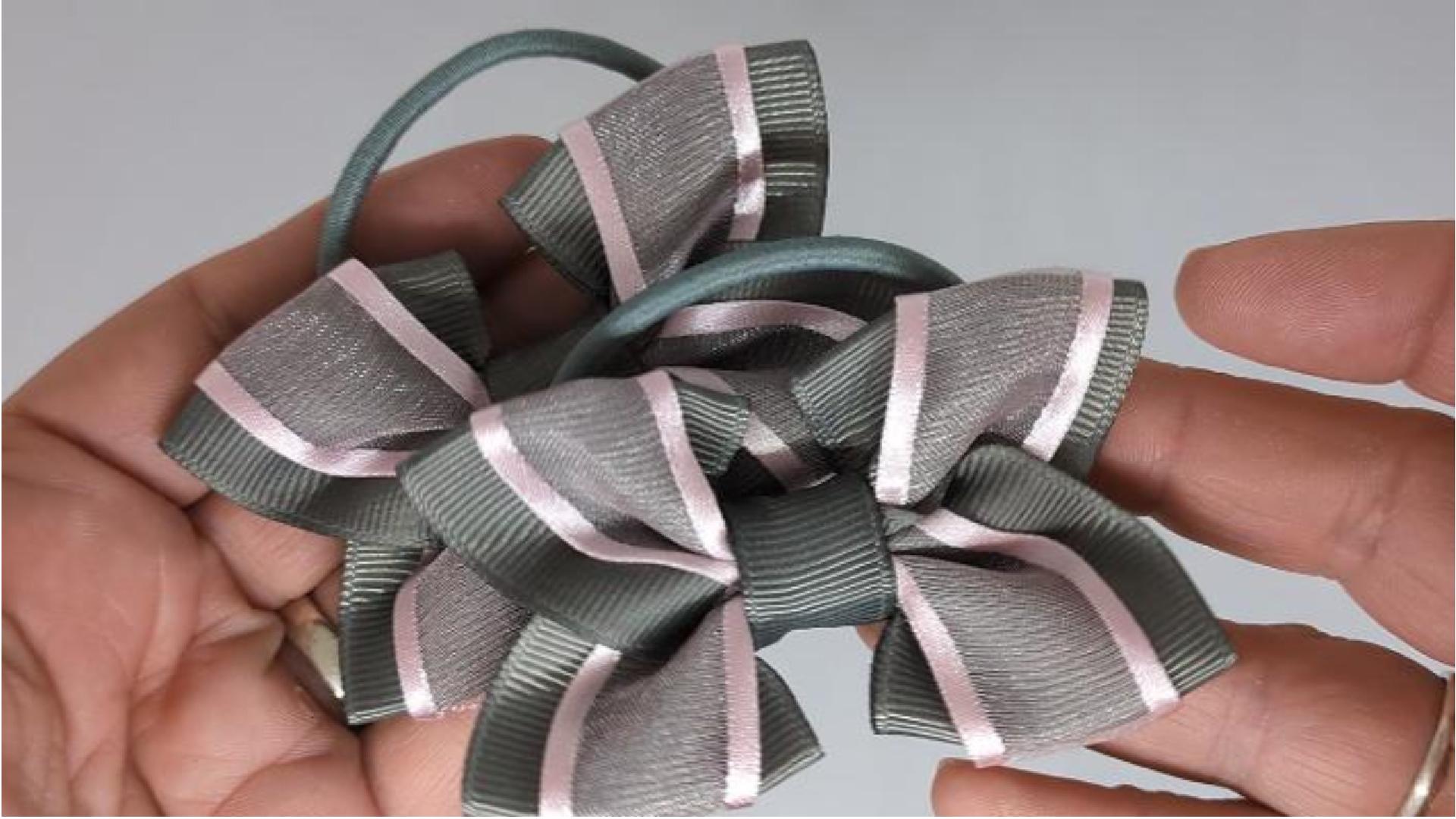 Close-up of school grey and pale pink hair bows on thick bobbles, measuring 9cm x 6cm, showcasing the soft grosgrain and organza ribbon combination.