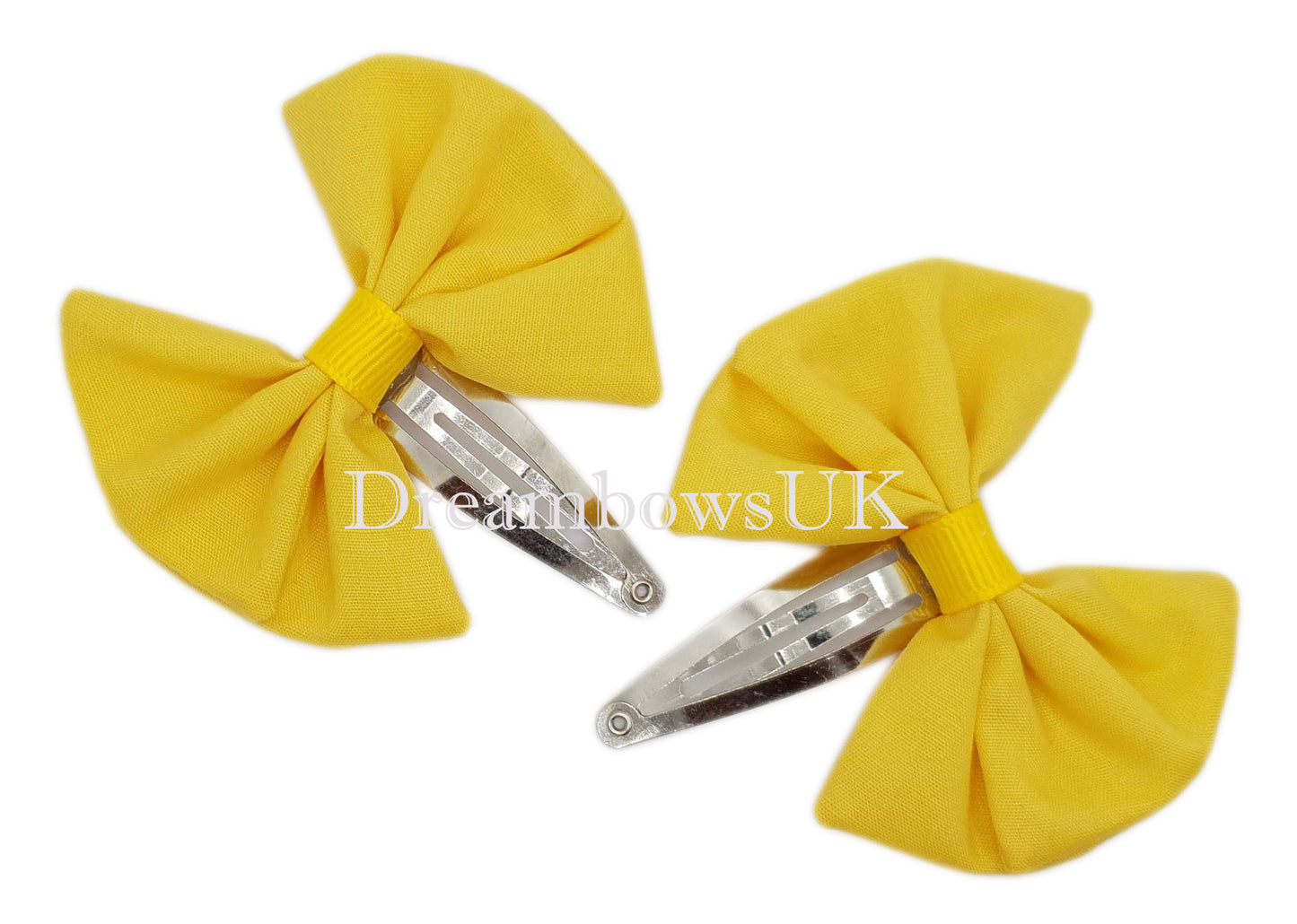 Golden yellow hair accessories on snap clips
