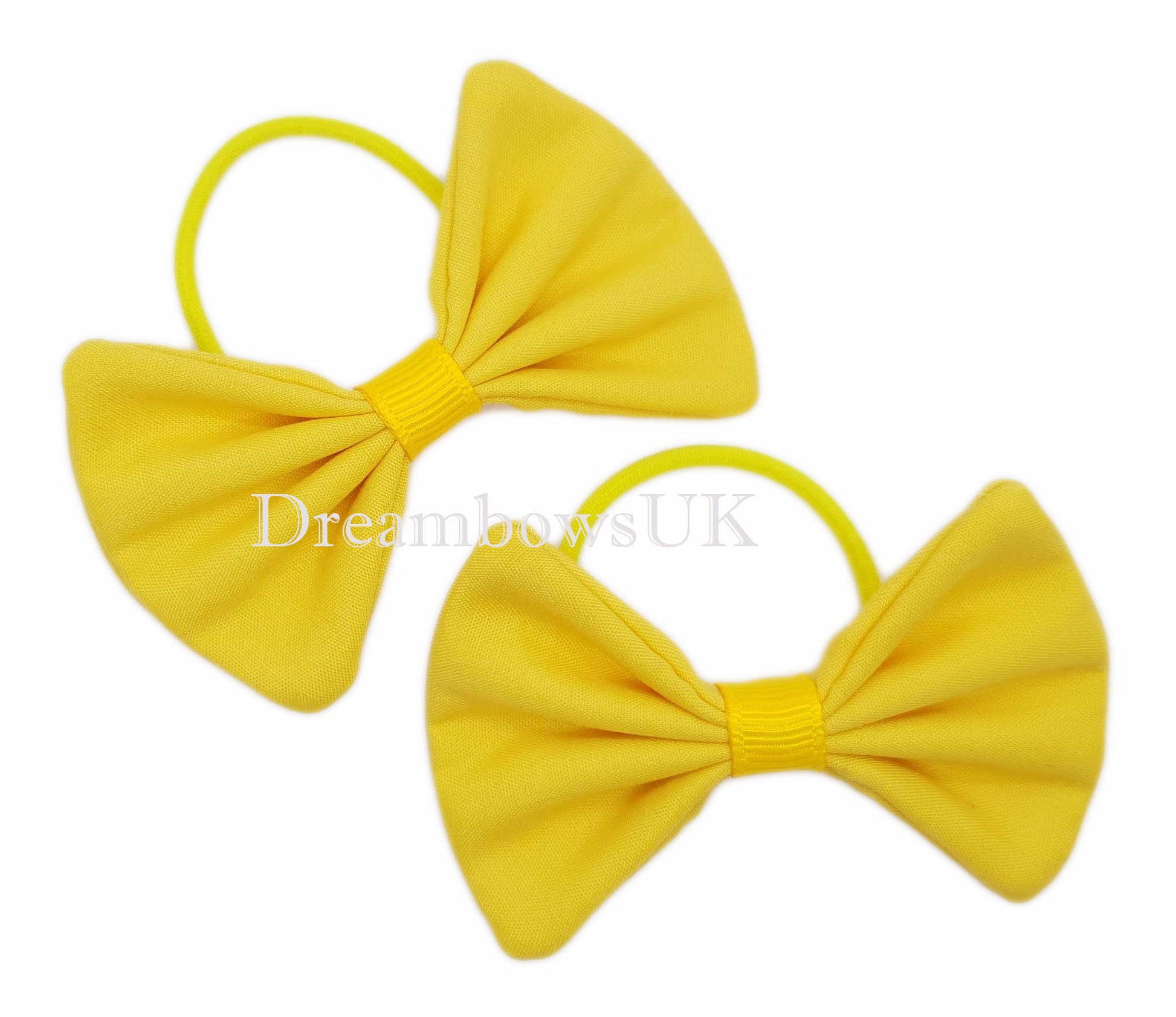 Golden yellow hair accessory bows on thin hair bobbles